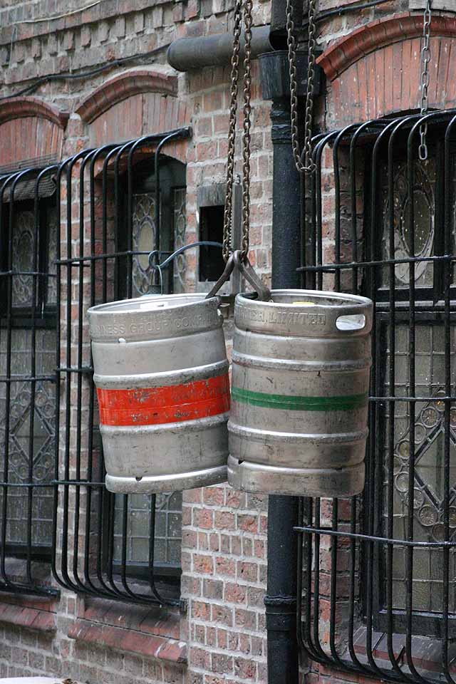 Beermats Photo of two steel beer kegs being hoisted into a pub in Liverpool