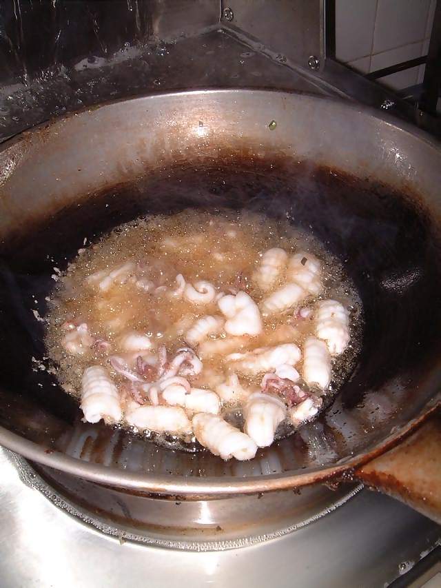 Food Chinese cooking in wok squid boiled in oil