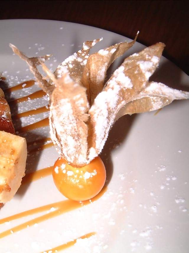 Food Decoration of fruit on Belgian waffle with caremilsed banana and caramel sauce