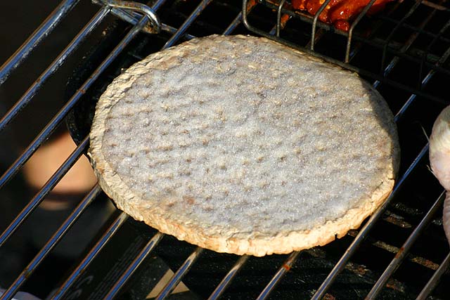 Food Frozen beef burger cooking on a garden barbecue