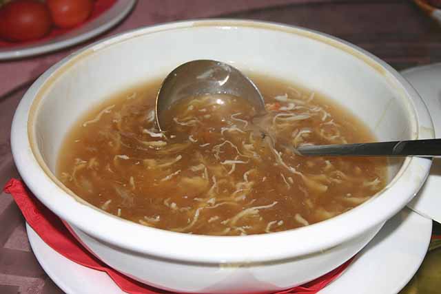 Food Large bowl of Sharks Fin Soup with a stainless steel ladle