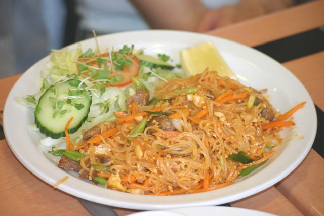 Food Pad Thai noodles with a side salad