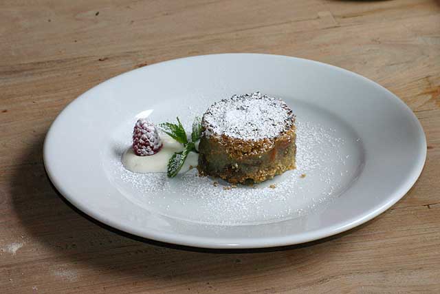 Food Photo of small artistic apple crumble with creme anglaise