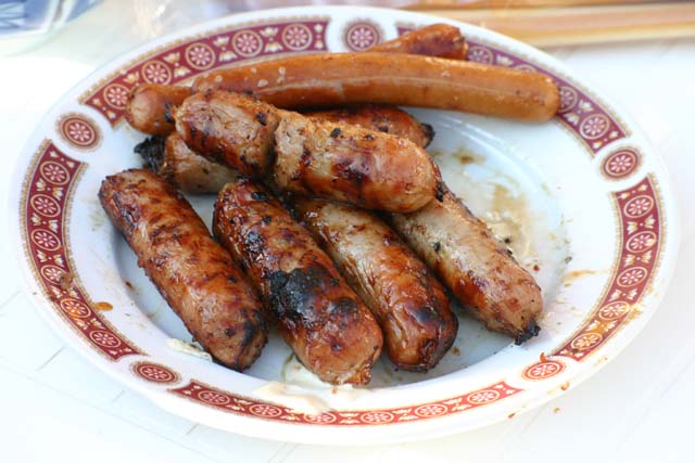 Food Plate of sausages that have been grilled on a garden barbeque