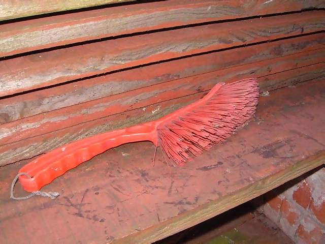 Miscellaneous Red hand brush on wooden planks