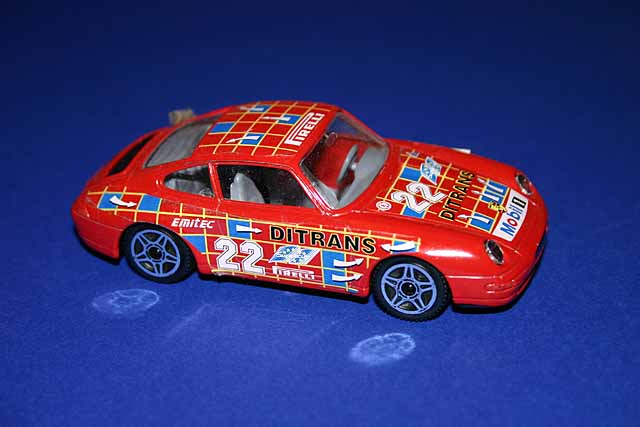 Models Porsche Carrera 911 model car withred paintwork and Ditrans Emitec and Pirelli livery