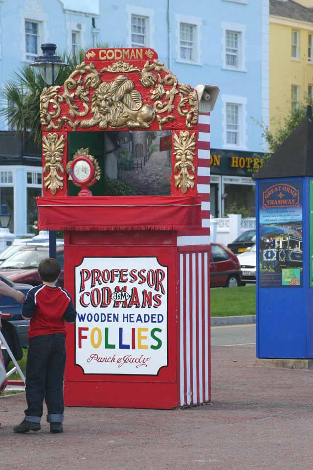 People Boy waiting for the next Punch and Judy show Professor Codmans Wooden Headed Follies