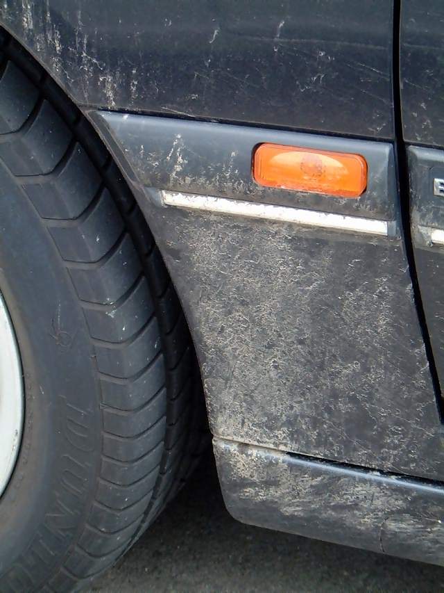 Vehicles Tyre and nearside indicator on mud splattered wing of Vauxhall Vectra