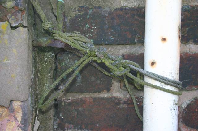 Old Green Rope Holding up White Metal Pole